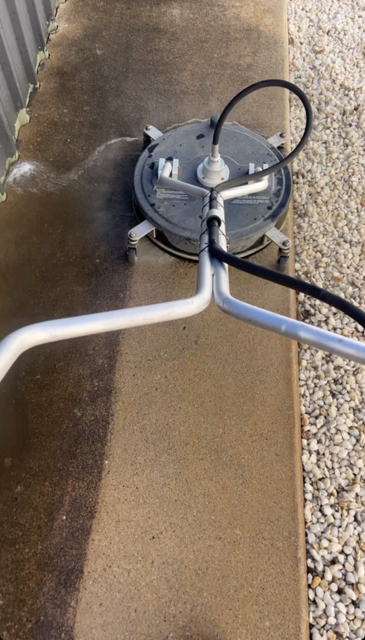 Pressure washer surface cleaner showing the dirty vs clean difference on a concrete path
